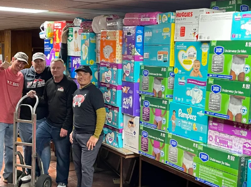 TC Backer team in front of donated diapers